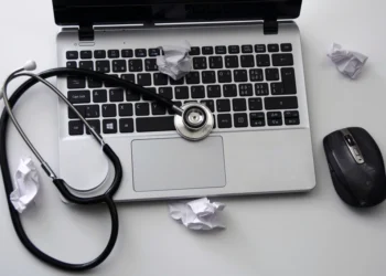 Doctor using computer related to Centricity EMR vs Athena EHR