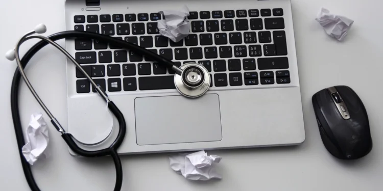 Doctor using computer related to Centricity EMR vs Athena EHR
