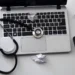 Doctor using computer related to Centricity EMR vs Athena EHR