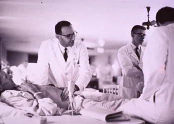 Doctor examining patient related to cleaning ears and removing ear wax safely