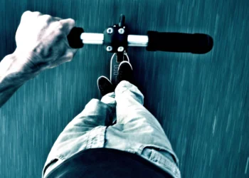 Adult riding an electric scooter like the Yume X7