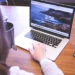 Person using a laptop to save online videos