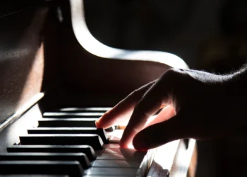 Hands playing piano related to choosing the best piano teacher near you