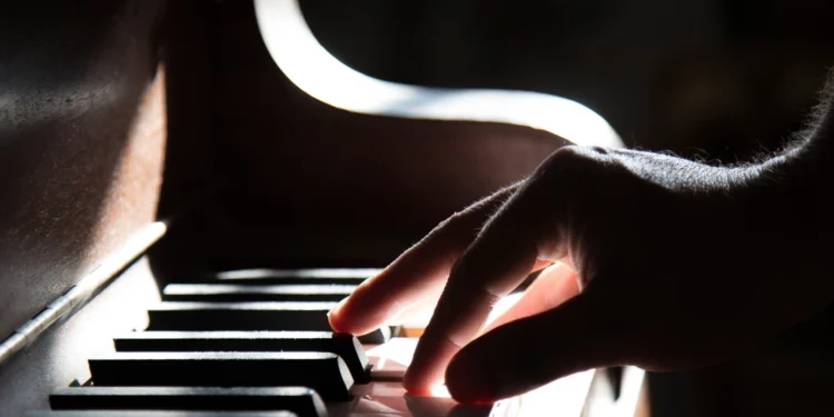 Hands playing piano related to choosing the best piano teacher near you