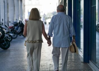 Senior couple walking hand in hand in a senior living community