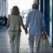 Senior couple walking hand in hand in a senior living community