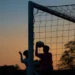 Children playing soccer at sunset