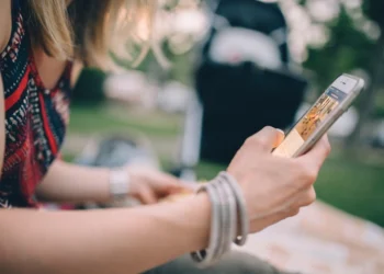 Young person using phone related to Covid, teens and eating disorders