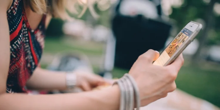Young person using phone related to Covid, teens and eating disorders