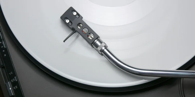 Vinyl record spinning on a turntable for a debut studio album release