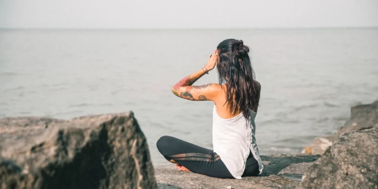 Woman sitting cross-legged and meditating