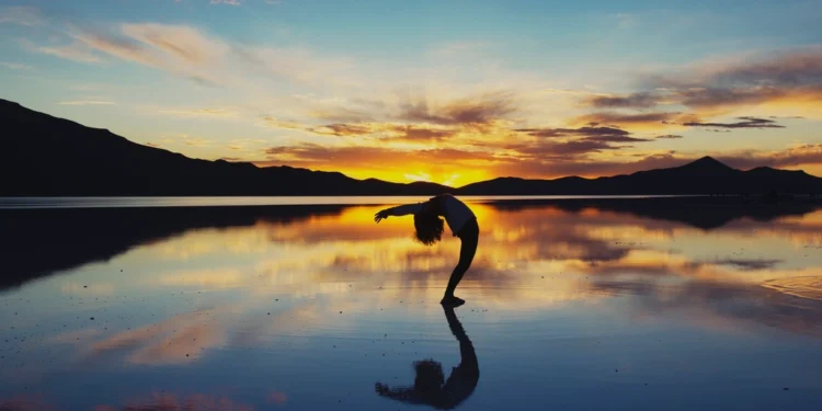 Woman doing yoga at sunset as a practice of self-love