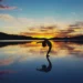 Woman doing yoga at sunset as a practice of self-love
