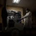 Radiology technologist with X-ray equipment used before spinal surgery