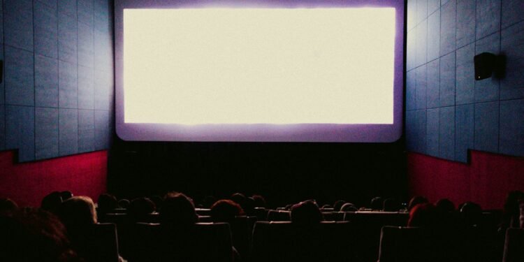 Audience watching one of the action movies of 2025 on a big cinema screen