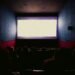 Audience watching one of the action movies of 2025 on a big cinema screen