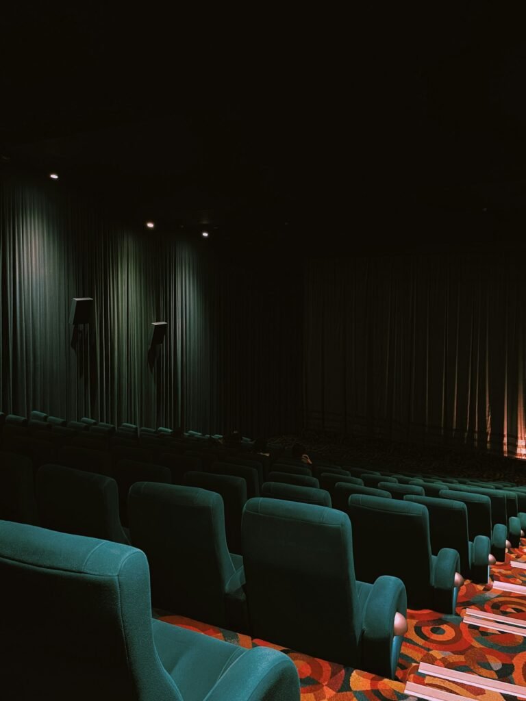 Rows of movie theater seats facing a large screen, ready for a 2025 action film