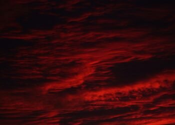 Dark red storm clouds, evoking the Stranger Things Mind Flayer and the Upside Down sky