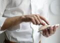 Person holding a smartphone to view Instagram anonymously
