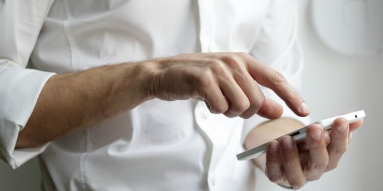 Person holding a smartphone to view Instagram anonymously